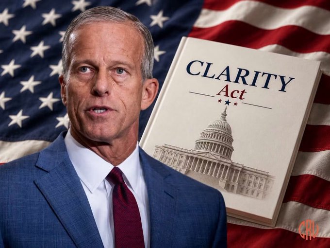 Senator John Thune is pictured next to a book titled "CLARITY Act," symbolizing the potential Senate vote on the bill. The image directly illustrates the subject of the accompanying text regarding the CLARITY Act.