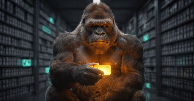 A digital rendering of a silverback gorilla holding a glowing yellow cube while sitting in what appears to be a dark server room with teal lights.