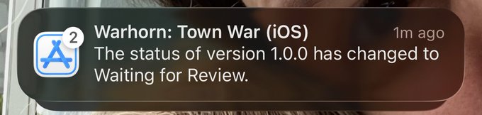 An iOS notification from the App Store stating "Warhorn: Town War (iOS) - The status of version 1.0.0 has changed to Waiting for Review."