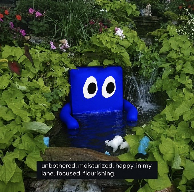 A blue square cartoon character with large eyes sits in a lush green garden beside a small waterfall, with the caption 'unbothered. moisturized. happy. in my lane. focused. flourishing.'