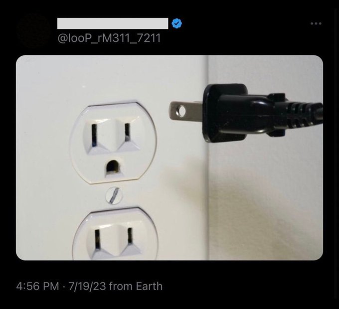 A Twitter post from @looP_rM311_7211 showing a photo of a US electrical outlet with a two-prong plug being inserted.