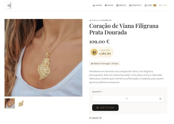 The image shows a computer screen displaying a webpage for a jewelry store, focusing on a gold necklace with a pendant featuring a floral design. The website allows customers to browse items and make purchases online. The store also accepts payments via Bitcoin. The main information displayed is about the necklace's price, which comes to $DOGE. This showcases that the business supports Bitcoin transactions as well.