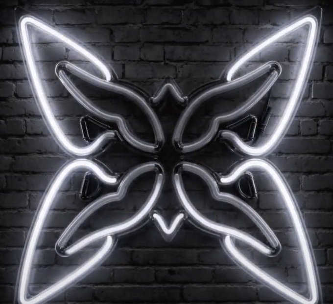 A glowing white neon butterfly sign mounted on a dark brick wall.