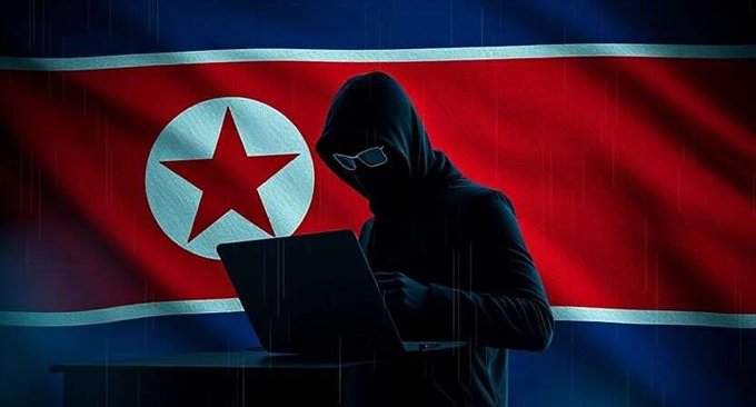 A hooded figure in a ski mask and sunglasses types on a laptop, silhouetted against the North Korean flag, symbolizing the anonymous hackers behind the Lazarus Group's $1.5 billion crypto heist that Bybit is now pursuing in court.