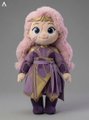 A small, stylized figurine of a character with pink hair wearing a purple outfit, resembling a fantasy or game character doll.