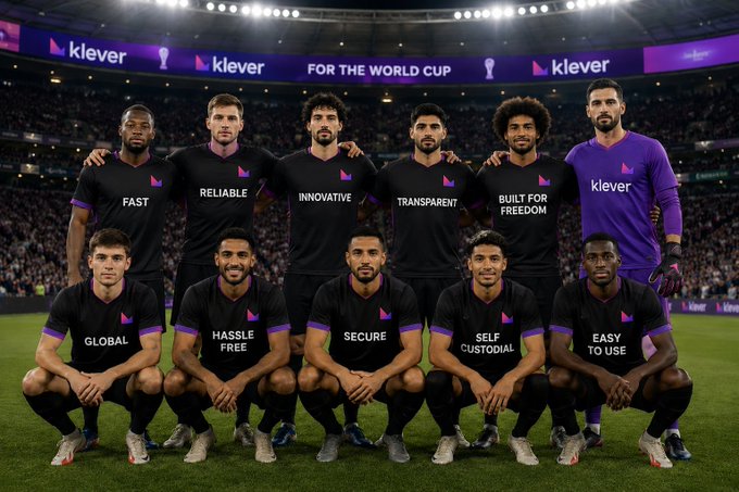The image features a group of soccer players posing for a photo, all wearing black uniforms with purple accents. The players are arranged in two rows, one on each side of the field, showcasing their unity as a team. In the background, there is a stadium filled with spectators, indicating that this could be an important match or event. The image also includes text related to the Klever Wallet cryptocurrency and its benefits for soccer teams, suggesting that the players are promoting financial literacy and investing in digital assets alongside their athletic pursuits.