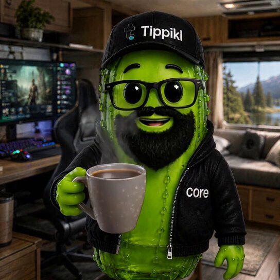The image features a green, cartoon-like figure holding a cup of coffee while wearing glasses and a hat with "TIPPIKL" written on it. The figure appears to be smiling, giving off a cheerful vibe. In the background, there is a TV screen mounted on the wall, suggesting that this scene takes place in a living room or entertainment area. A keyboard can also be seen nearby, indicating that someone might have been working at the computer desk earlier.