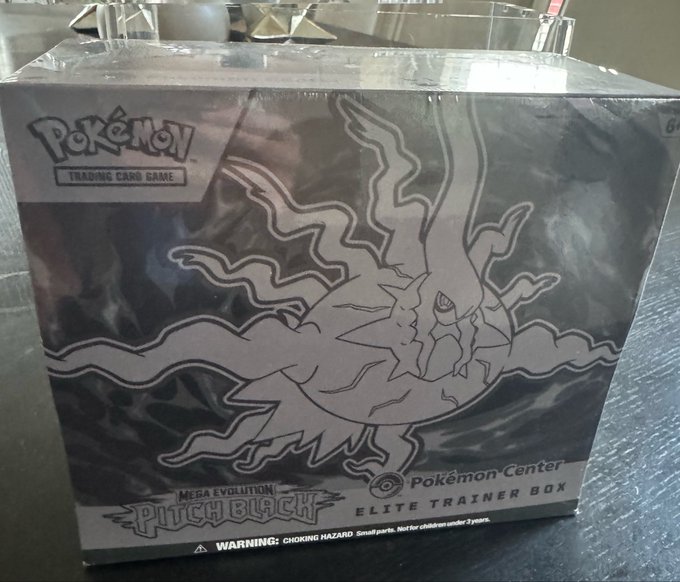 A sealed Pokémon Trading Card Game 'MEGA EVOLUTION PHANTOM BLACK' Elite Trainer Box from Pokémon Center, featuring line art of a legendary Pokémon on the packaging.