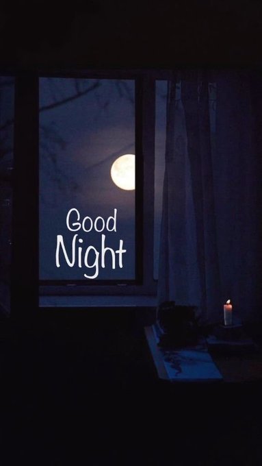 A view through a window at night shows a full moon in the dark sky, with the text 'Good Night' overlaid, while a lit candle sits on the windowsill below.