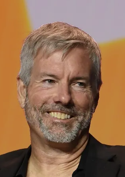 A smiling, gray-bearded man in a dark jacket appears at what looks like a press event or conference, likely representing Michael Saylor, founder of Strategy (formerly MicroStrategy). The post highlights Goldman Sachs' significant $386M purchase of MSTR shares, bringing their holdings to $558M.