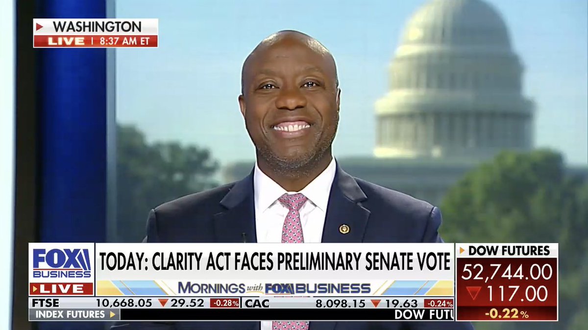 Sen. Tim Scott appears on "Mornings with Fox Business" from Washington, with a chyron reading "Today: Clarity Act Faces Preliminary Senate Vote," alongside market data showing Dow Futures at 52,744.00 (-117.00, -0.22%), FTSE at 10,668.05 (-0.28%), and CAC at 8,098.15 (-0.24%). The image visually corresponds to the post, capturing the senator during his live appearance discussing the digital asset legislation.
