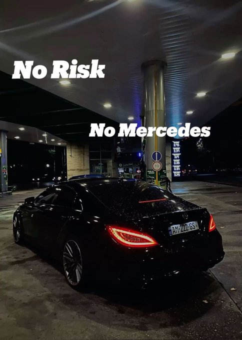 A black Mercedes-Benz coupe parked at a gas station at night, overlaid with the white text 'No Risk No Mercedes'.