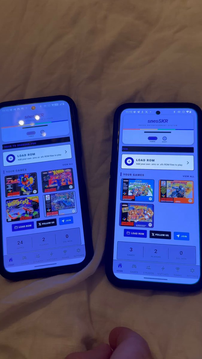 The image shows two cell phones placed side by side, both displaying a blue screen with white text. One of the phones has a "player" app icon on its home screen, while the other phone does not have any visible apps or icons. The background is a beige color, and there are no texts or other objects in the image.
