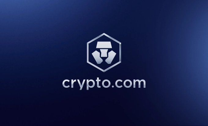 The crypto.com logo featuring a hexagonal emblem with a 'C' shape displayed on a dark blue gradient background.