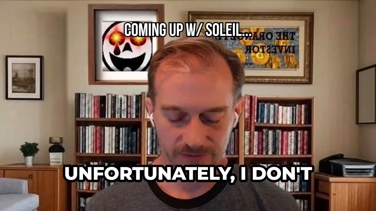 A man with reddish-brown hair and a goatee looks down in what appears to be a home office with bookshelves and framed artwork behind him, including a "THE ORACLE INVESTOR" print and a Jack Skellington-style skull with glowing eyes. Overlaid text reads "COMING UP W/ SOLEIL..." and "UNFORTUNATELY, I DON'T," suggesting this is a teaser clip from an interview with the crypto commentator known as Soleil.
