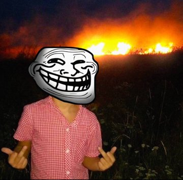 A person in a pink checkered shirt with a troll face meme superimposed over their head, standing in front of a large outdoor fire with 'FJF' overlaid in large text.