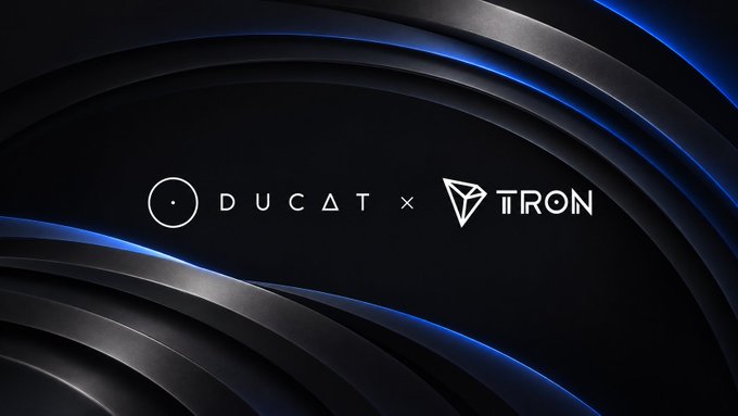 The image features a sleek, dark banner with curved metallic edges accented in blue, prominently displaying the "DUCAT × TRON" logos side by side, symbolizing the partnership between Ducat and the TRON blockchain. The branding visually reinforces the announcement of Ducat launching wUNIT on TRON with USDT swap access.