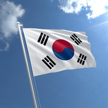 The image features a white flag with black stripes, flying high against a blue sky with clouds. The flag displays the Korean flag design of a circle with a red center surrounded by black stripes. Below the flag, there's text that reads "JUST IN: SOUTH KOREAN FINANCIAL GIANT TOSS BANK IS SET TO USE @SOLANA FOR ITS GLOBAL remittance AND SETTLEMENT POC (15 MILLION+ CUSTOMERS!)". The image seems to be related to the post about South Korean financial giant Toss Bank's global settlement and remittance services.