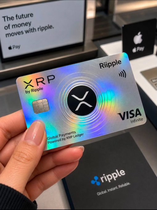A hand holding a holographic Ripple XRP by Visa Infinite card, with an Apple Pay display reading 'The future of money moves with ripple' in the background.
