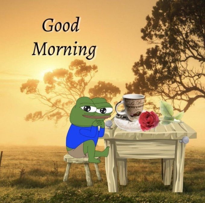 A 'Good Morning' greeting image featuring a Pepe the Frog character sitting at a wooden table with a coffee cup and red rose, set against a golden sunset landscape with silhouetted trees.