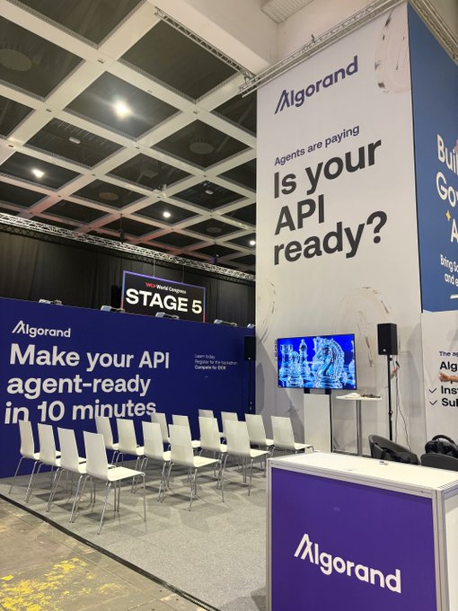 Algorand booth at a conference with signage reading 'Agents are paying. Is your API ready?' and 'Make your API agent-ready in 10 minutes.'