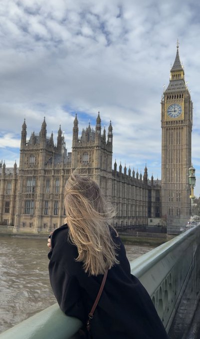 A woman gazes across the Thames at Big Ben and the Palace of Westminster, embodying an early morning adventure in London.