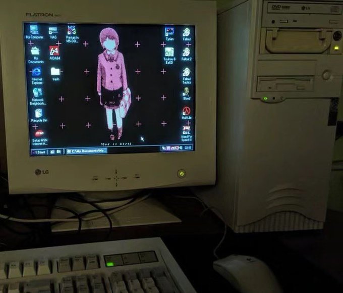 An old desktop computer setup featuring a Flatron LG monitor displaying a desktop wallpaper of an anime-style character, alongside a beige LG tower PC, keyboard, and mouse.