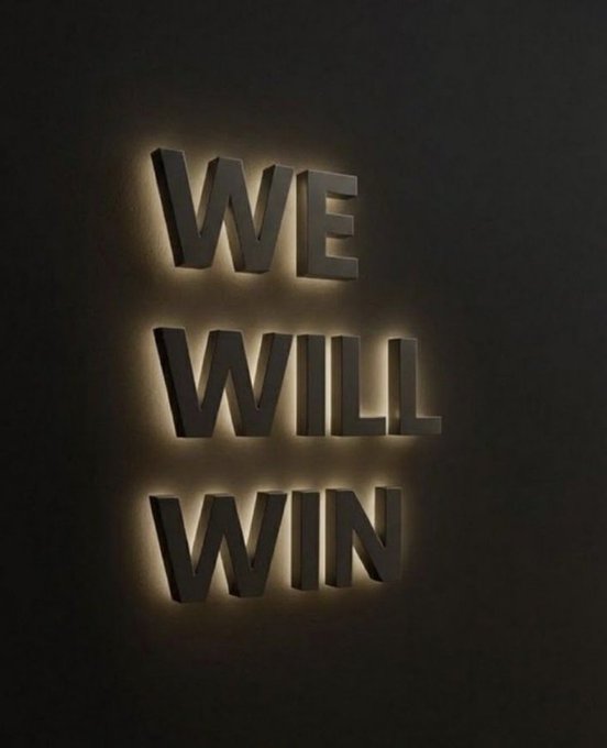 The image displays the illuminated phrase "WE WILL WIN" in bold, three-dimensional lettering on a dark wall, serving as a motivational backdrop fitting for the "GM Legends" post celebrating achievement and victory.