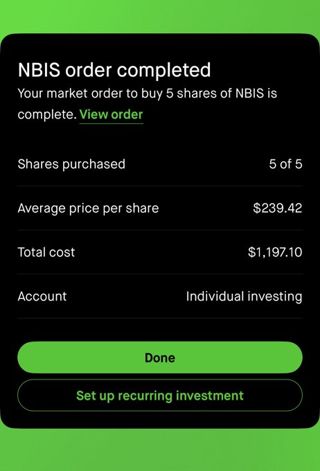 The image shows a screenshot of an NBITS trading app, specifically the section titled "Order Complete". This text confirms that the order has been successfully completed at $NBIS. The green color used throughout indicates that the market conditions are favorable for investing in NBIS shares of NBSIs. Keep up with the rising price and watch your investment grow!