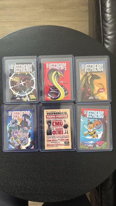 Six collectible 'VE FRIENDS' trading cards displayed on a black surface, featuring various cartoon characters and artwork including a snake, dragon, and 'Farm Fights' promotional card.