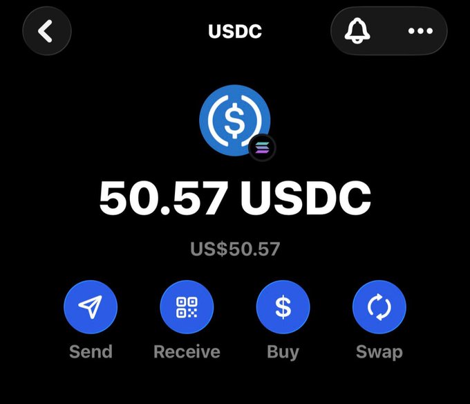 A crypto wallet screen displaying a balance of 50.57 USDC (US$50.57) with Send, Receive, Buy, and Swap options, shown alongside a giveaway post promising $50 to one winner who drops their Solana address in the comments.