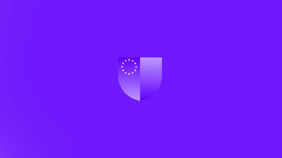 The image features a purple shield graphic with a white border against a blue background. The shield has a curved top and bottom, giving it an elegant appearance. The text "From cloud computing to blockchain infrastructure" suggests that the image may be related to the world of technology or digital innovation. The caption reads "@iota understands what comes next", which implies that the image is likely associated with the company @iota, a tech company based in Europe known for its innovative solutions and understanding of emerging technologies.
