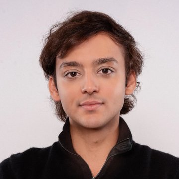 A headshot of Mirza Uddin, Head of Business Development at Injective, pictured in a black collared shirt against a neutral background, accompanying his quote about Injective's ambition to become one of the largest stablecoin companies globally.