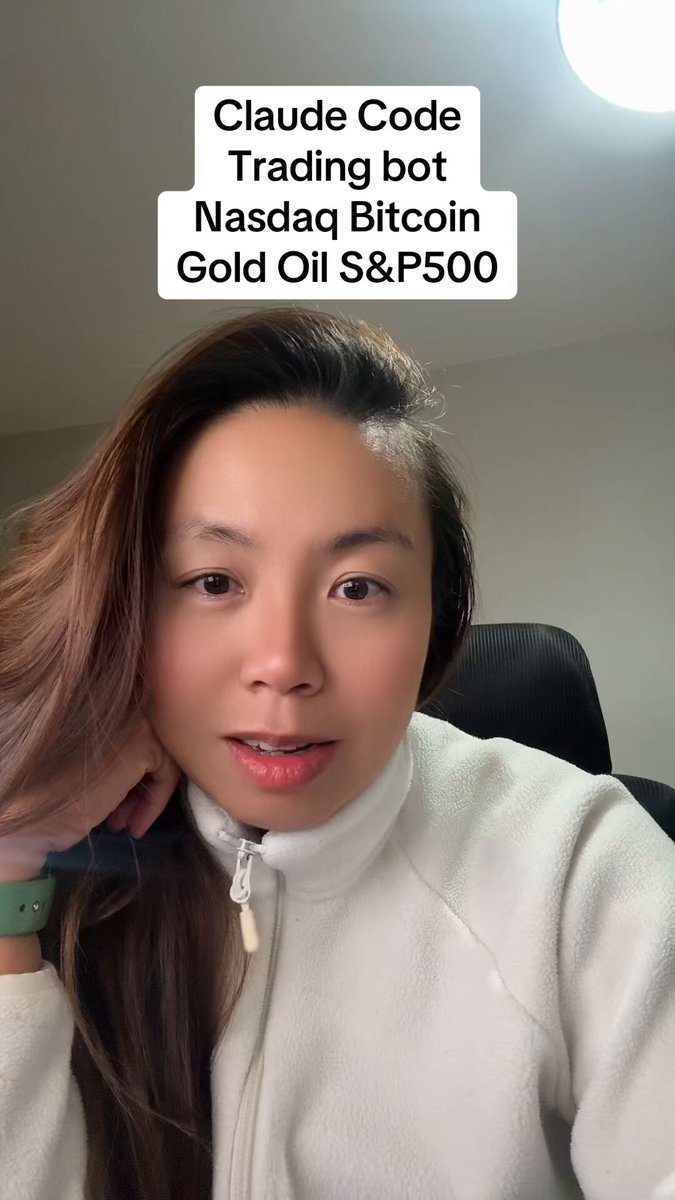 The image features a woman wearing a white jacket who appears to be smiling at the camera while sitting down. The background of the photo shows a chair where she is seated. There are also some text elements visible, including "Claude Code", "Trading bot", and "Nasdaq Bitcoin Gold Oil S&P 500". It seems that the woman might have been involved in trading these assets or has an interest in them. The image does not provide any specific information about the content of the trading bot's code or the nature of the assets it is trading, but it does show a connection to the trading bot and its purpose.