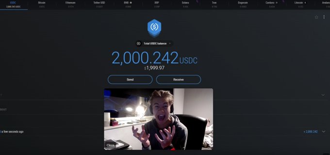 The image shows a person sitting at a desk with a computer screen displaying a message about receiving $2,000 as a donation. The person appears to be excited or surprised by this unexpected gift. The text of the message includes details such as the USDC ERC-20 addresses and the fact that it is a free donation.