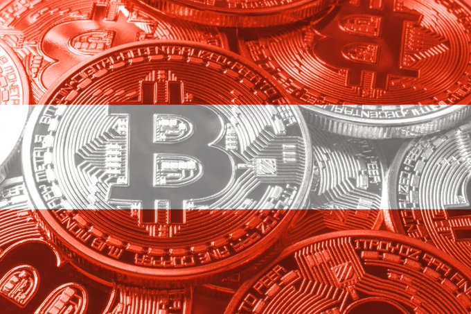A close-up image of multiple Bitcoin coins overlaid with a red and white graphic, possibly representing the Austrian flag or a similar color scheme.