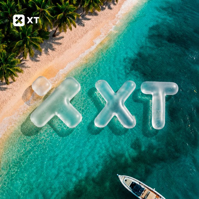 An aerial view of a tropical beach with palm trees and turquoise water features inflatable "XT" letters floating offshore alongside a small boat, visually promoting the #XTexchange hashtag and inviting viewers to imagine their ideal summer destination through the XT brand.