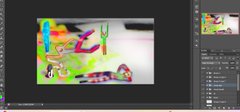 A computer screen showing a photo editing software interface, likely Photoshop, with a colorful, abstract image being edited.
