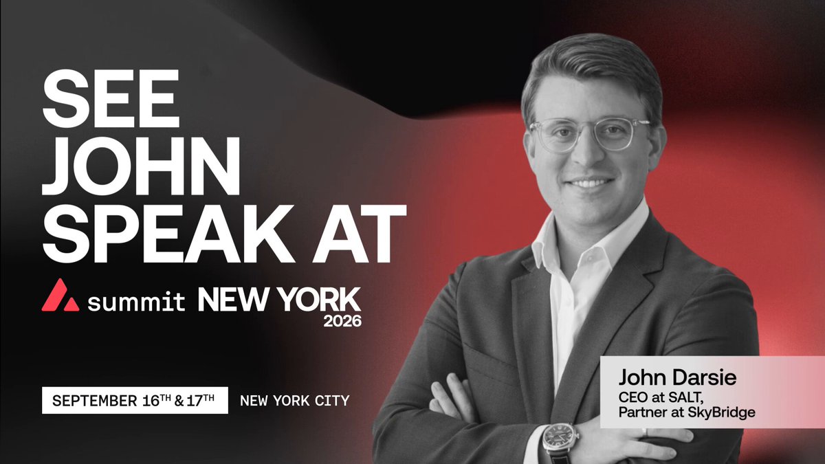 The image features a man wearing glasses and a suit standing next to a banner that says "See John Speak At Summit New York 2008". The text on the banner indicates that this event is related to cryptocurrency, as it's called the Avalanche Summit. The man in the image appears to be smiling for the camera, suggesting he might be excited about attending or promoting the summit.