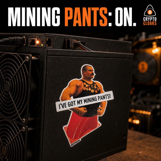 Advertisement for Crypto Cloaks featuring a sticker of a muscular man in red pants with the text 'I'VE GOT MY MINING PANTS!' on a crypto mining rig, headlined 'MINING PANTS: ON.'