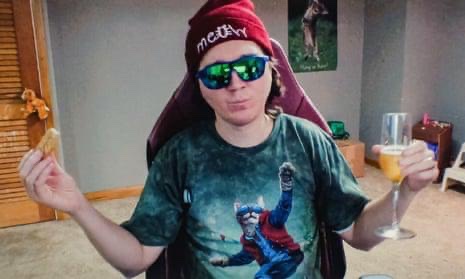 A person wearing a red beanie, reflective sunglasses, and a t-shirt featuring a cat in a superhero cape raises a toast with a champagne glass, embodying the triumphant, community-driven memecoin spirit referenced in the post about $TENDIES potentially overtaking $Cashcat.