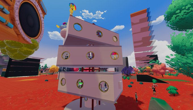 A vibrant 3D virtual world scene featuring a multi-level pink tower with circular character windows, set against a bright blue sky with colorful trees and fantastical architecture.
