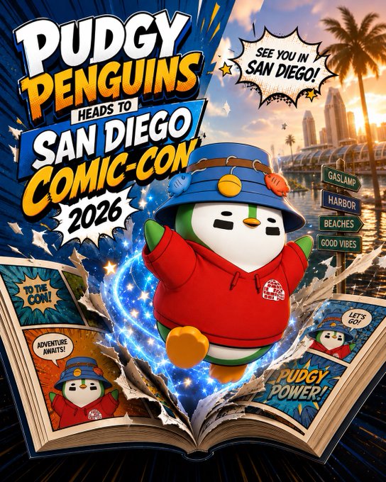 The image features a poster for Puddly Penguin heads to San Diego Comic-Con. The poster showcases a cartoon penguin wearing a red shirt, standing out against a blue background with white stars. The penguin appears to be holding an open book in its beak and is surrounded by various comic book characters. The text on the poster reads "See you in San Diego! Puddly Penguin heads to San Diego!"