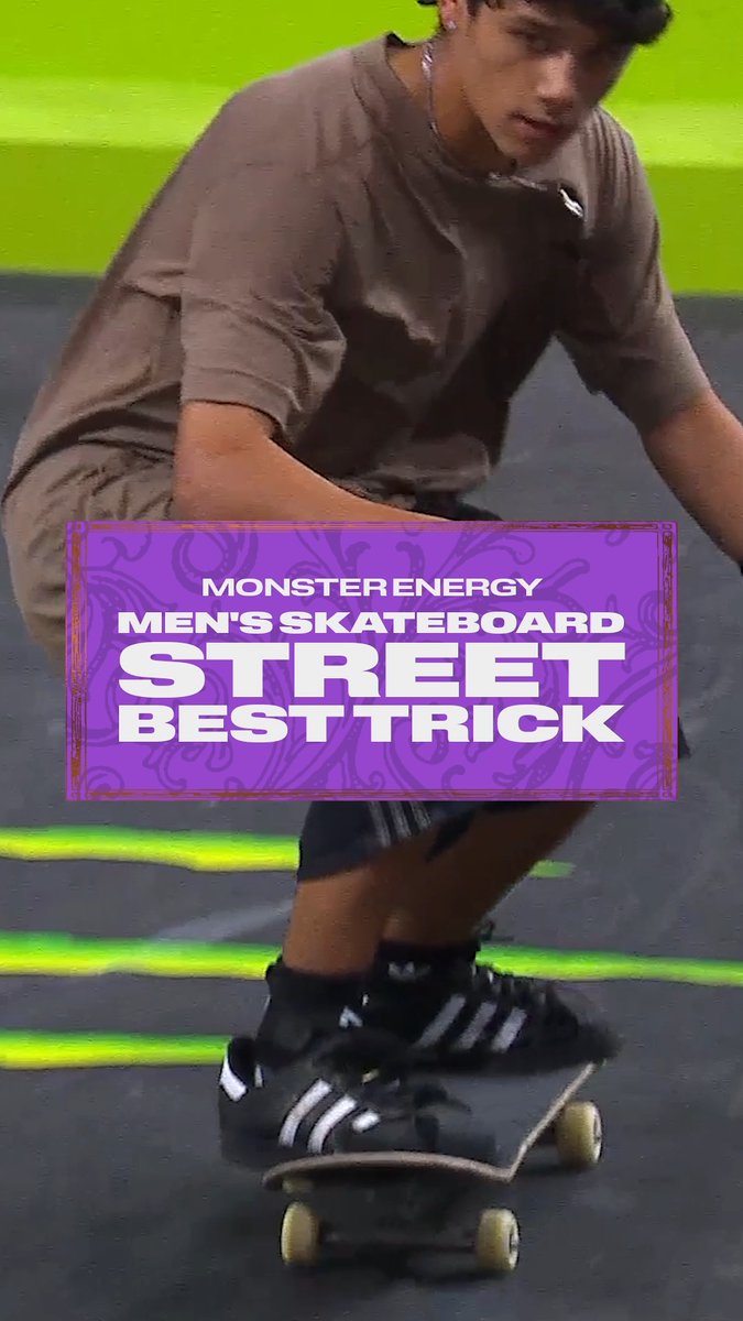 A skateboarder crouched on his board during a competition, with a purple banner reading 'MONSTER ENERGY MEN'S SKATEBOARD STREET BEST TRICK'.
