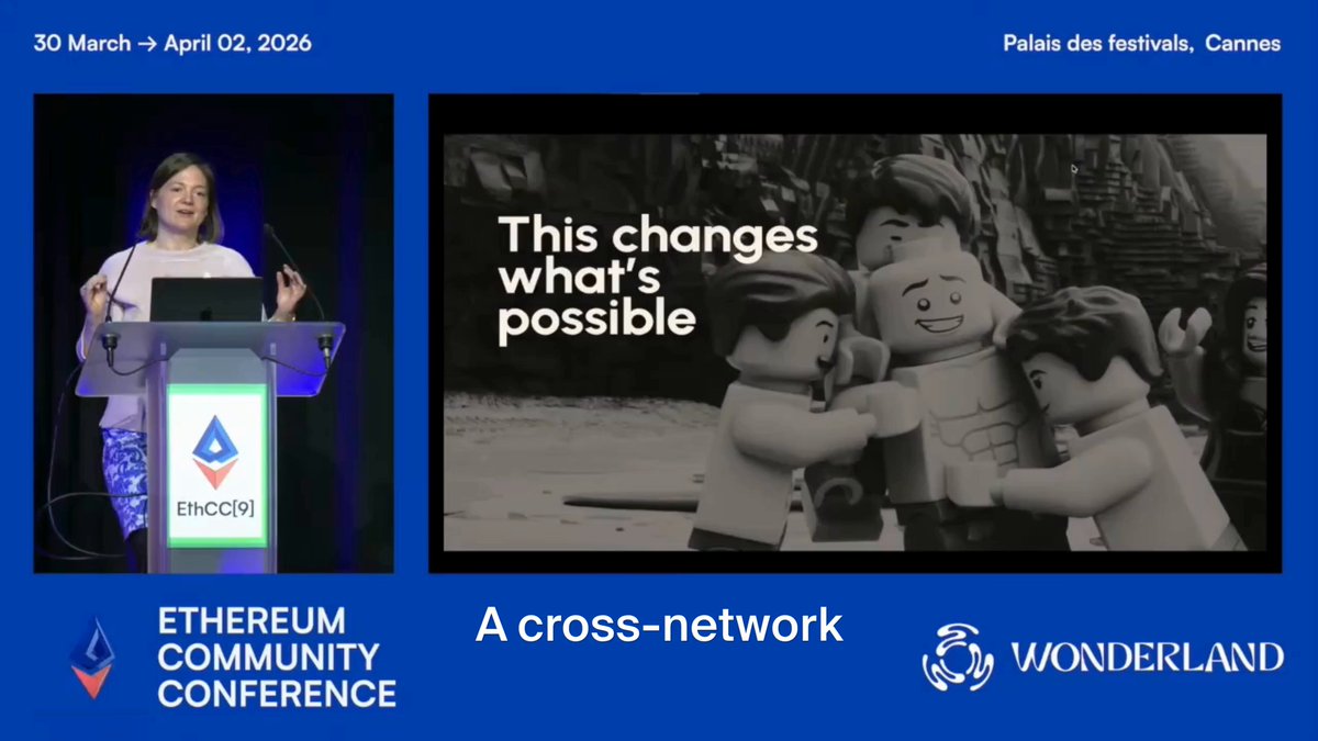 The image features a woman standing at a podium, giving a speech or presentation. She appears to be addressing an audience of Lego figures, which are positioned behind her. The scene suggests that she might be discussing the benefits of the Ethereum Economic Zone for the Ethereum community.