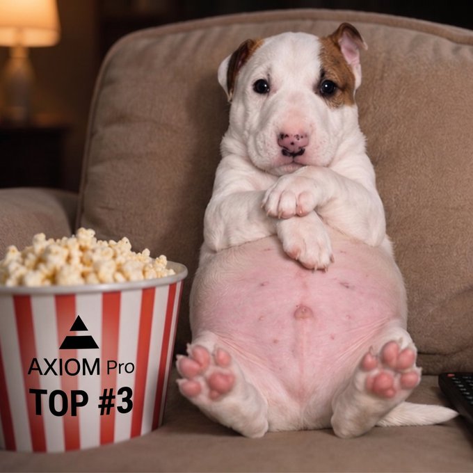 A photo of a bulldog puppy sitting on a couch next to a striped popcorn bucket labeled "AXIOM Pro TOP #3."