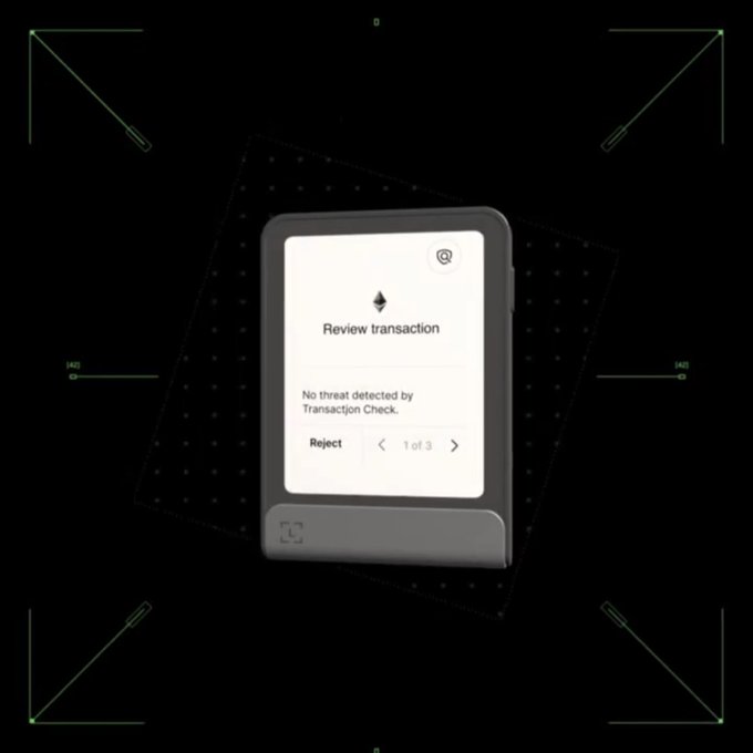 The image features a Ledger hardware wallet displaying a "Review transaction" screen with the message "No threat detected by Transaction Check," showing a "Reject" option and "1 of 3" navigation. This relates to the post by highlighting the Ledger device's clear signing feature that could potentially be exploited by the Ethereum app vulnerability, which the firmware update aims to fix.