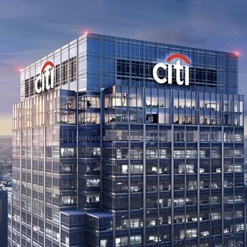A glass skyscraper displaying the 'citi' logo on its facade against a blue sky.