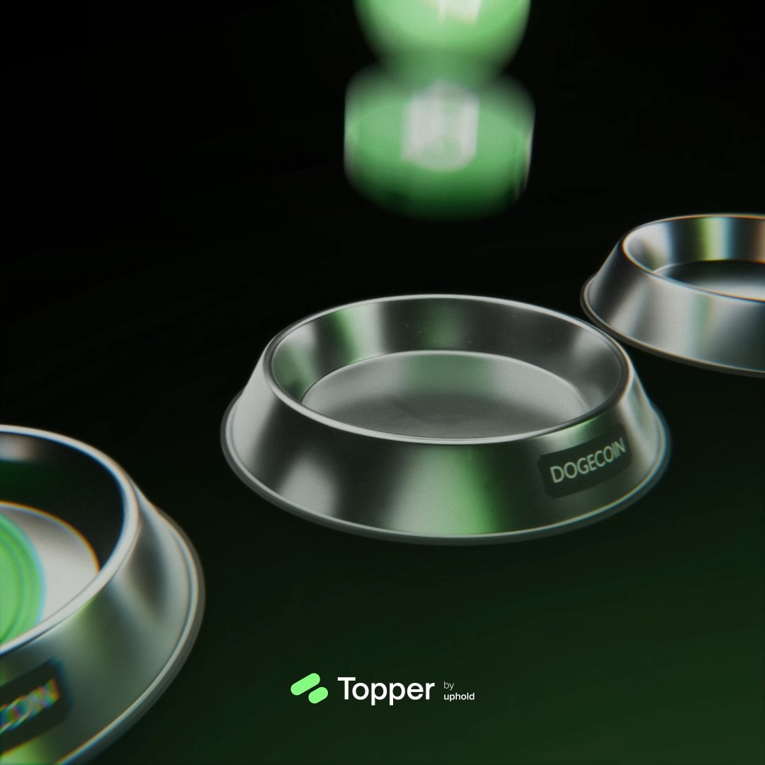 A stylized 3D render of metallic dog bowls on a dark reflective surface, with one labeled 'DOGECOIN' and a 'Topper by uphold' logo at the bottom.