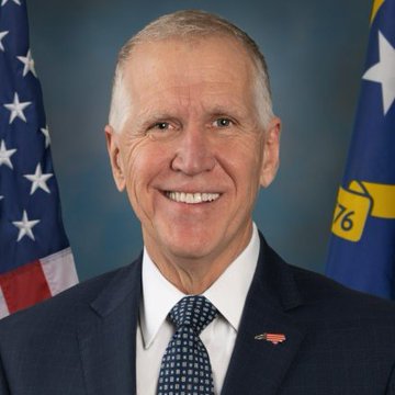 Senator Thom Tillis smiles in an official portrait, wearing a dark suit with a patterned tie and American flag lapel pin, standing before an American flag and a North Carolina state flag displaying "76."

The image relates to the post as an official portrait of Senator Thom Tillis (R-NC), the lawmaker referenced as having filed a motion to reconsider the CLARITY Act following Tuesday's cloture vote.